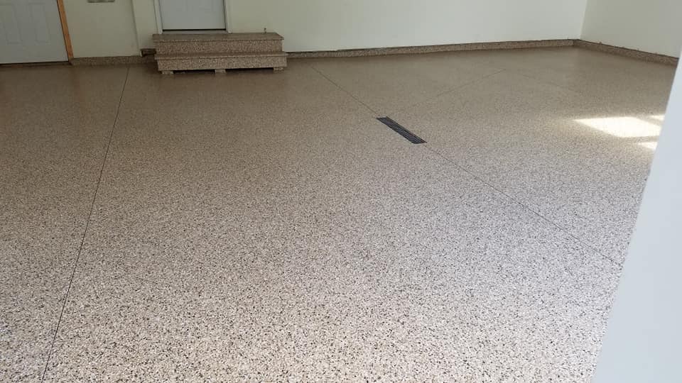 new garage floor with outback chip coating on floor and steps into house