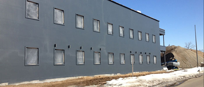 sprayed-on air barrier completed on commercial building exterior