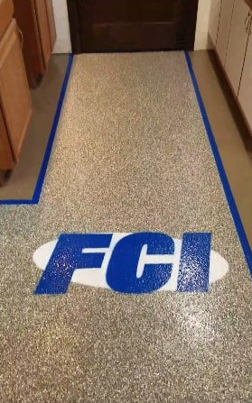office floor coating in traffic area and company logo embedded in the floor