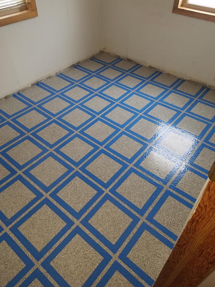 flecked floor coating with blue grid line pattern