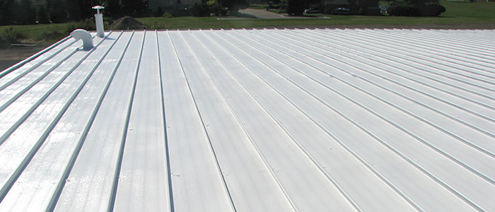 seamless roof coating applied to a flat metal roof